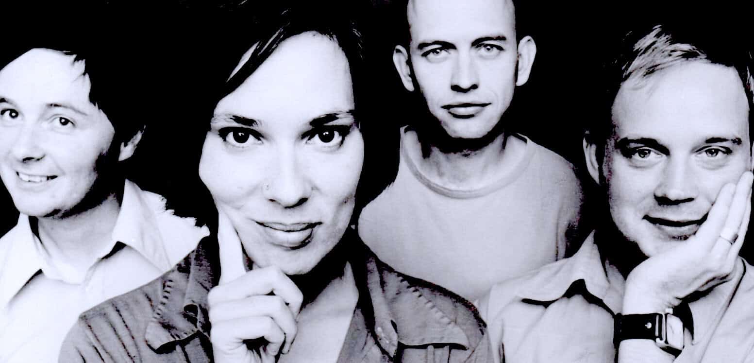 A black and white image of four diverse individuals posing confidently, representing music, news, and cultural history for a sound archive platform.