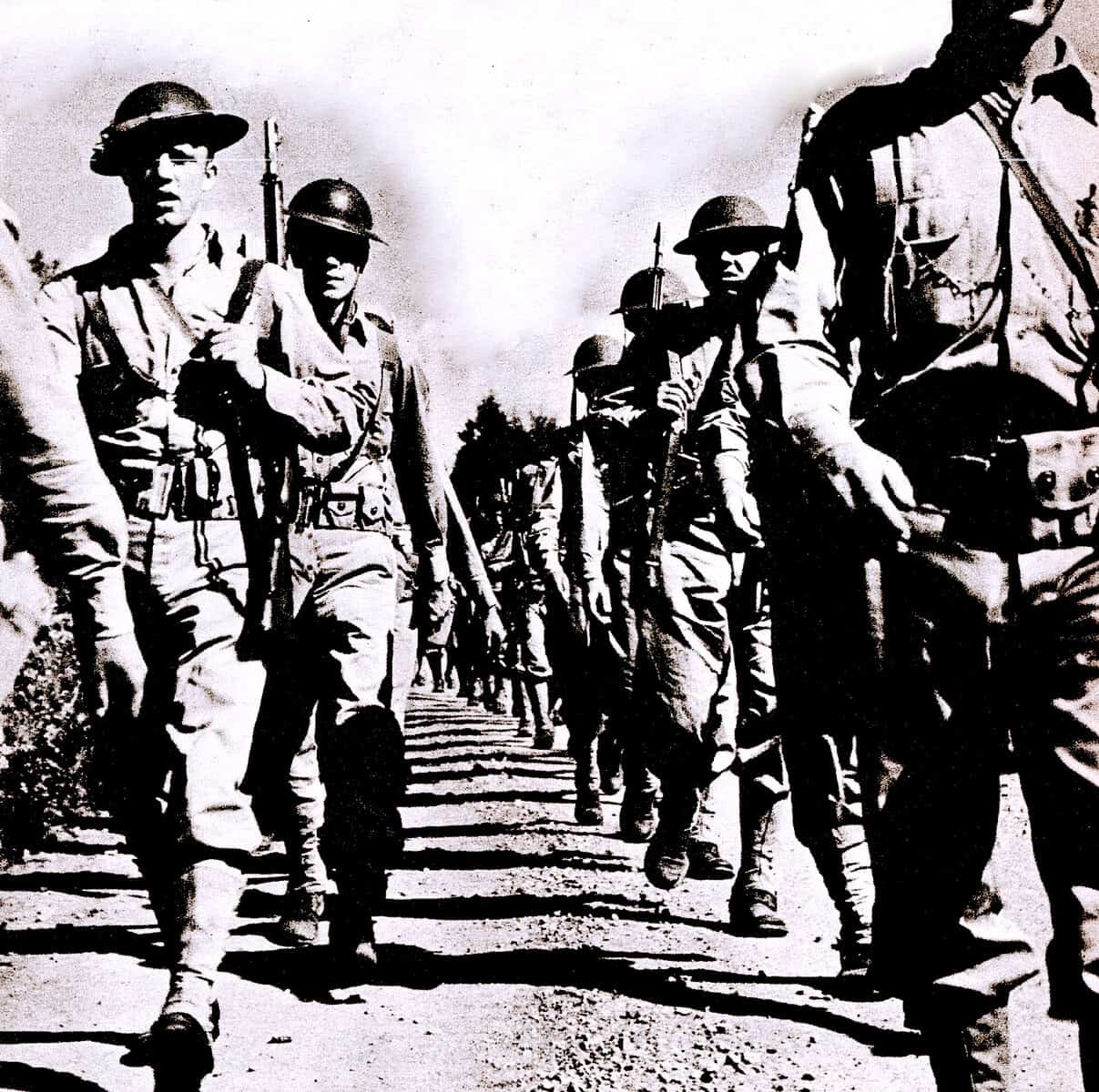 Soldiers marching in military uniform during wartime, black and white historical photograph, illustrating war, military, history, and soldiers.