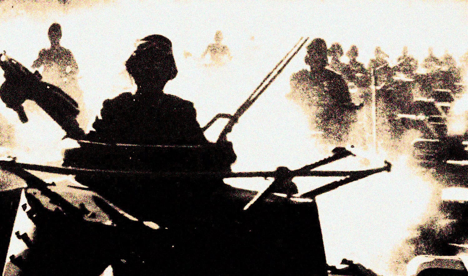 Silhouette of a soldier in a tank during wartime, emphasizing military history and conflict imagery for historical archives.