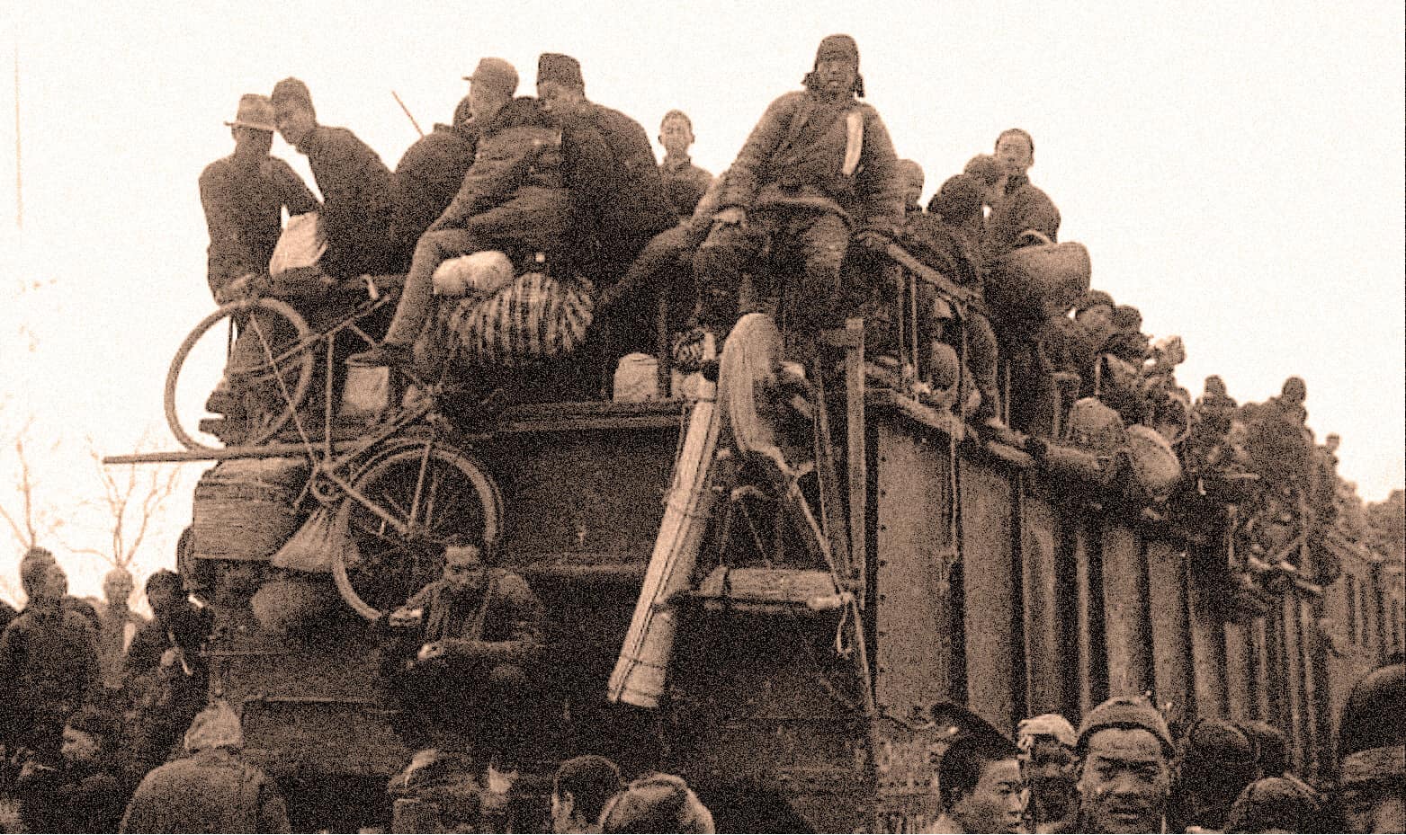 Overcrowded train with people traveling, vintage black and white photo emphasizing historical news and migration stories on Past Daily archive site.