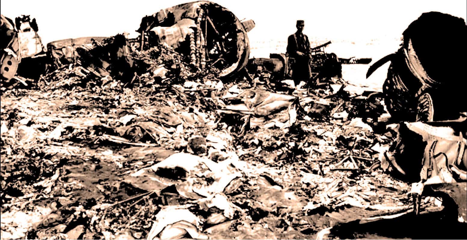 Blown-up image of wreckage and debris from a tragic accident site, with damaged vehicles and scattered belongings, capturing the aftermath of a disaster or collision.