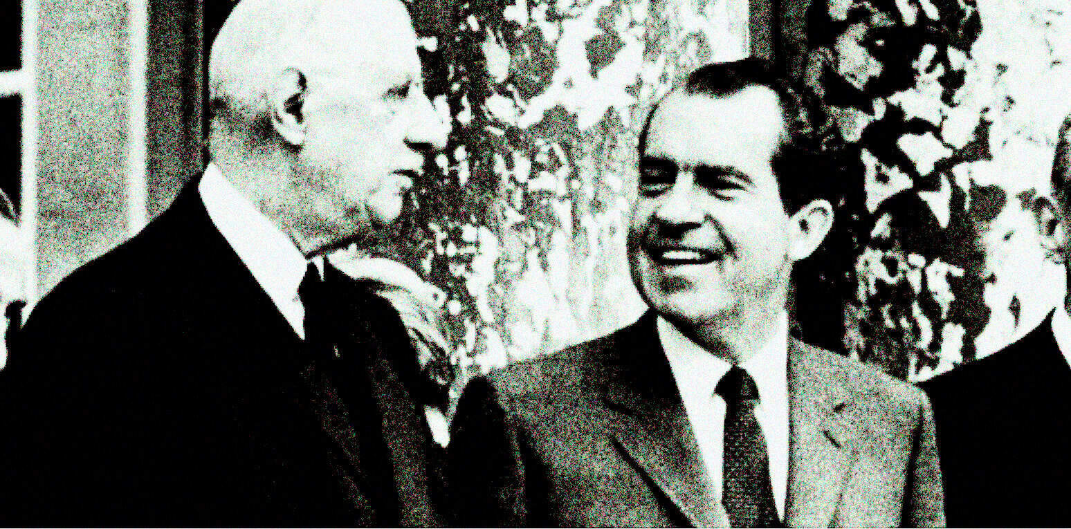 Historic black and white photo of prominent political figures engaged in conversation during a formal event, highlighting news, history, and notable personalities.
