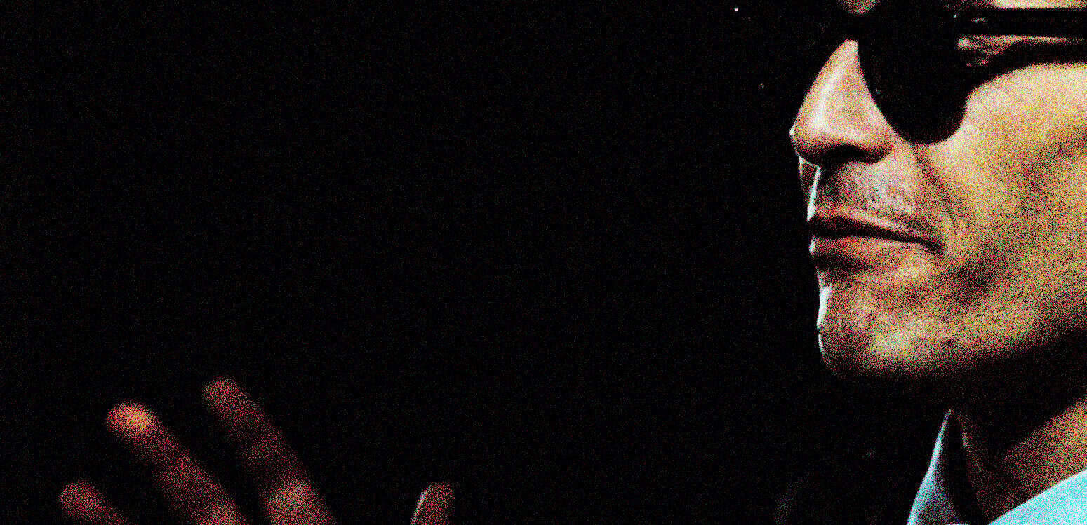 Vintage photograph of a man wearing sunglasses, highlighting classic style and musical influence, related to past news, history, and music archives.