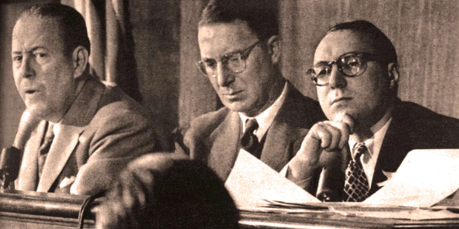 Historian panel discussion about news and history archives, vintage photo of men in suits and glasses, archival image illustrating historical news analysis, vintage black and white photograph of 1950s news experts.