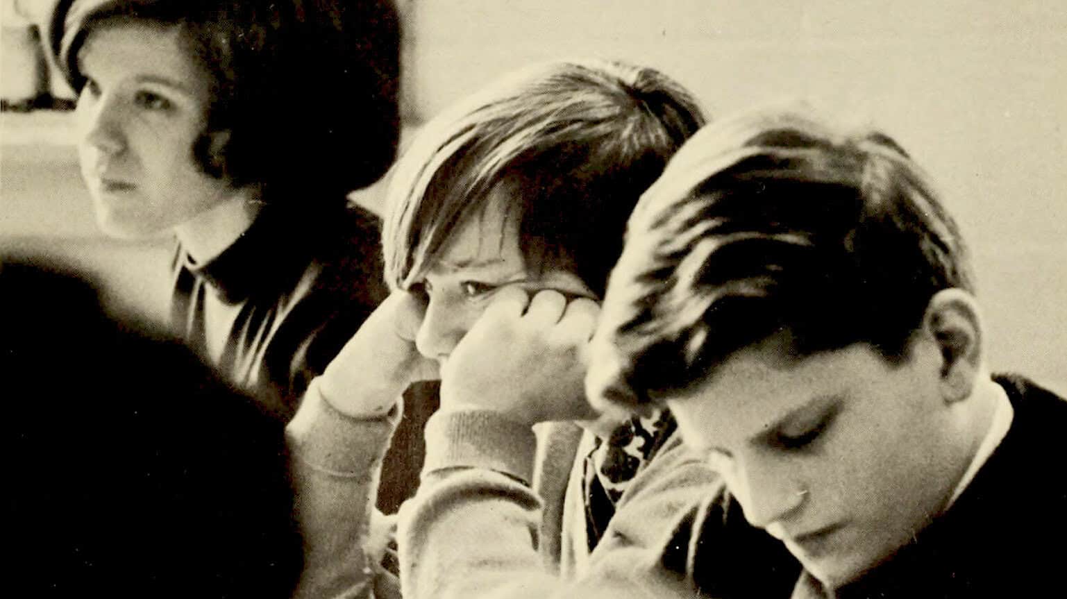 Students studying music theory in a classroom, black and white photo, focused teenage girls with short hair, learning about music history and news, part of a sound archive of past music and cultural history, educational environment, nostalgic vibe, vintage photo of youth engaging with music history.