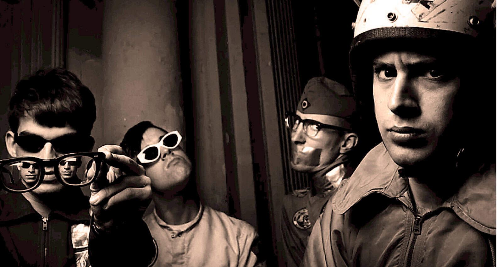 Past daily music archive, vintage band in leather jackets and retro sunglasses, black and white photo, cult classic, alternative rock, 1960s vibe, iconic music history, nostalgic sound archive, historical photo, music and pop culture memorabilia, news and history photography, timeless musical moments.
