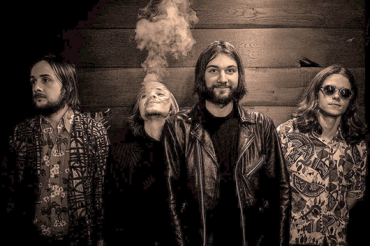 Musical band members in casual clothing, vintage style photo, rock band, music group, alternative music, band portrait, 1970s style, grunge fashion, music history, band promotional image.