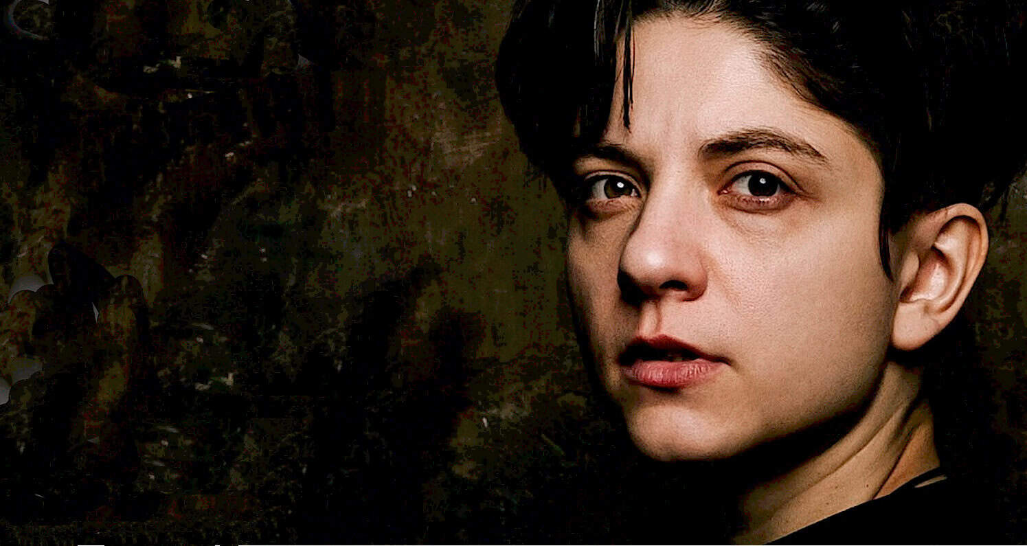A close-up portrait of a woman with short dark hair, looking intently at the camera, representing an archival image related to music, history, and news, from the Past Daily sound archive website.