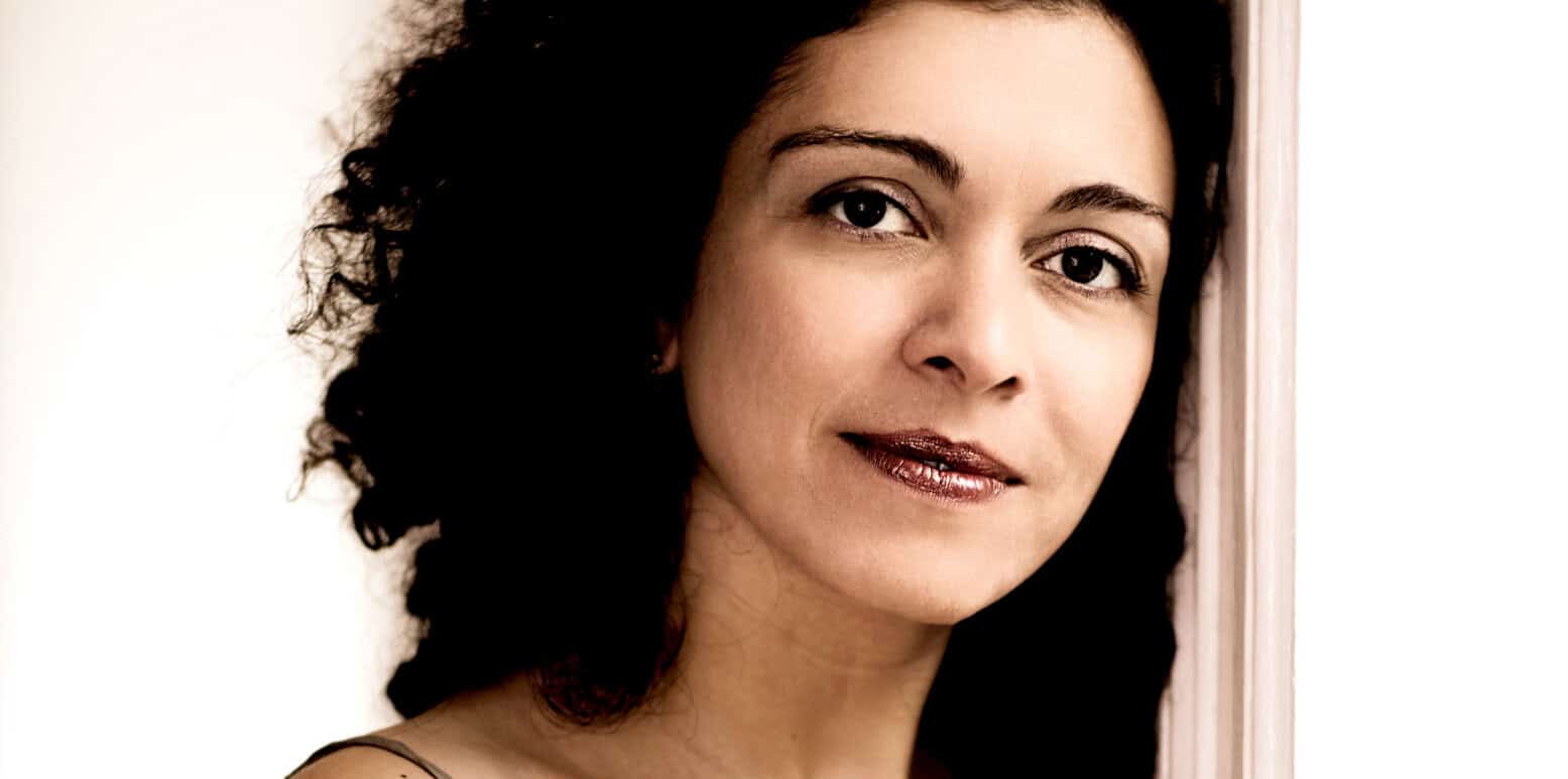 Elegant woman with dark hair, clear skin, and subtle makeup, representing timeless beauty and confidence, featured in an image associated with historical news, music, and sound archives.