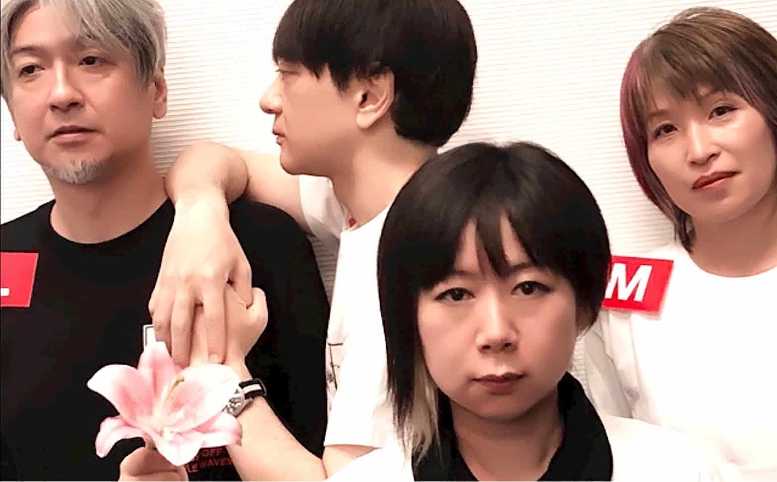 People of diverse Asian ethnicities posing together at a music or news event, promoting past daily sound archive of news, history, and music.