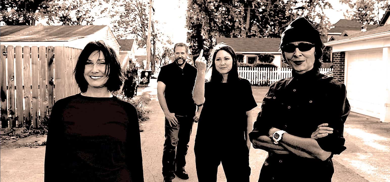 Vintage-style photo of four diverse people standing in a suburban backyard, capturing themes of urban life, social identity, and contemporary culture.