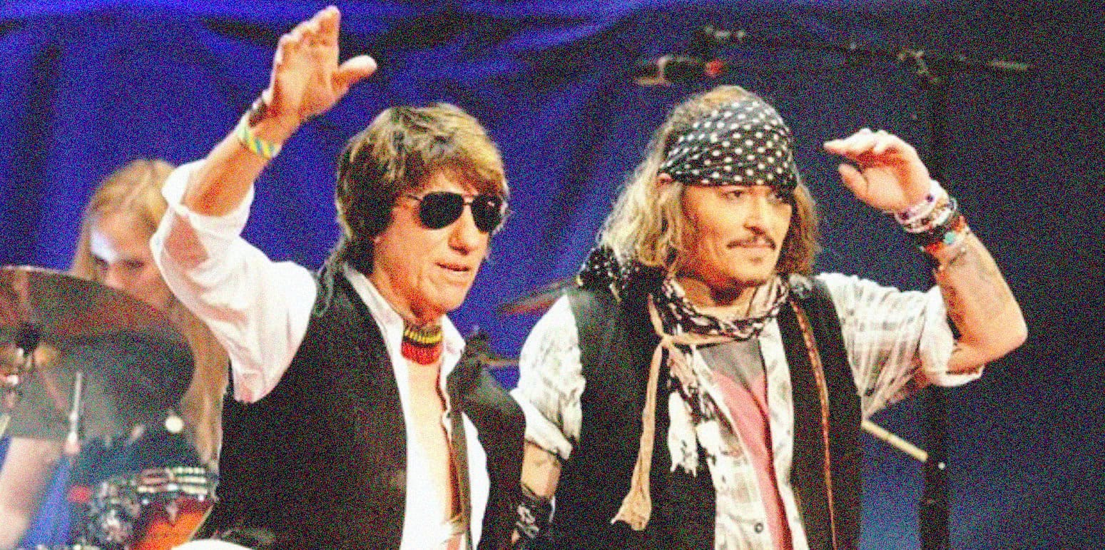 Rock musicians David Bowie and Steven Tyler performing on stage at a music concert, rock legends, iconic music performance, 80s rock stars, live music event.