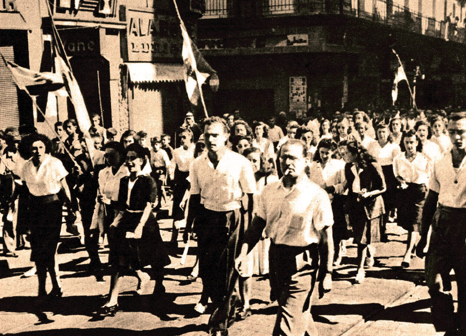 Vintage black-and-white photo of a political demonstration with young protesters holding flags, evoking historical news, music, and events captured in the Past Daily audio archives.