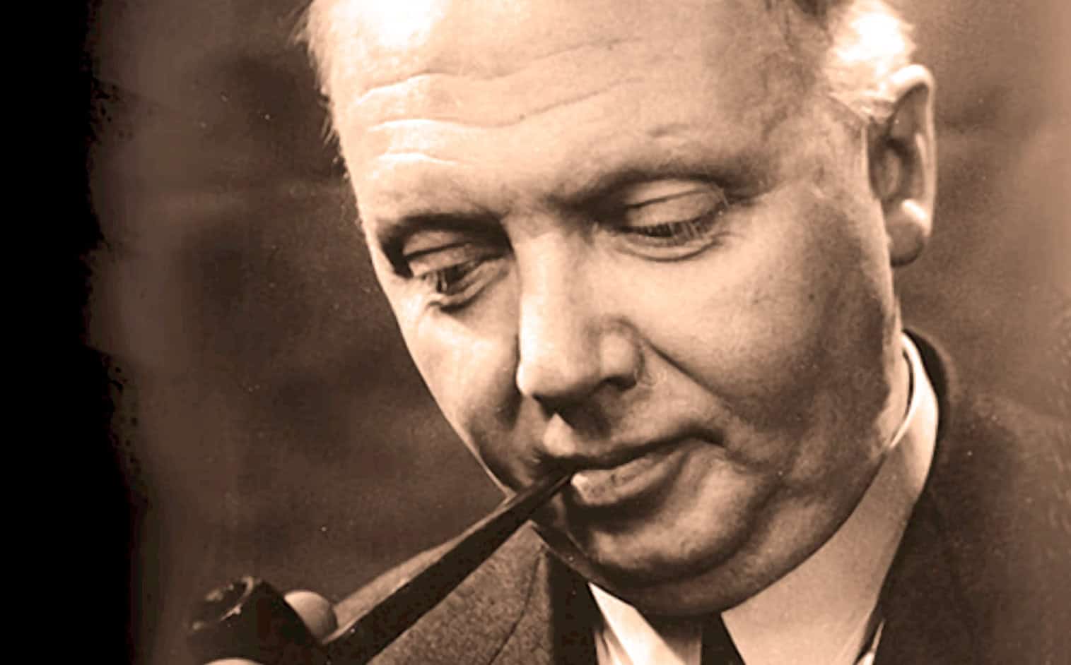 Vintage black and white photo of a distinguished man with a pipe, representing historical news, music, and sound archives from Past Daily.
