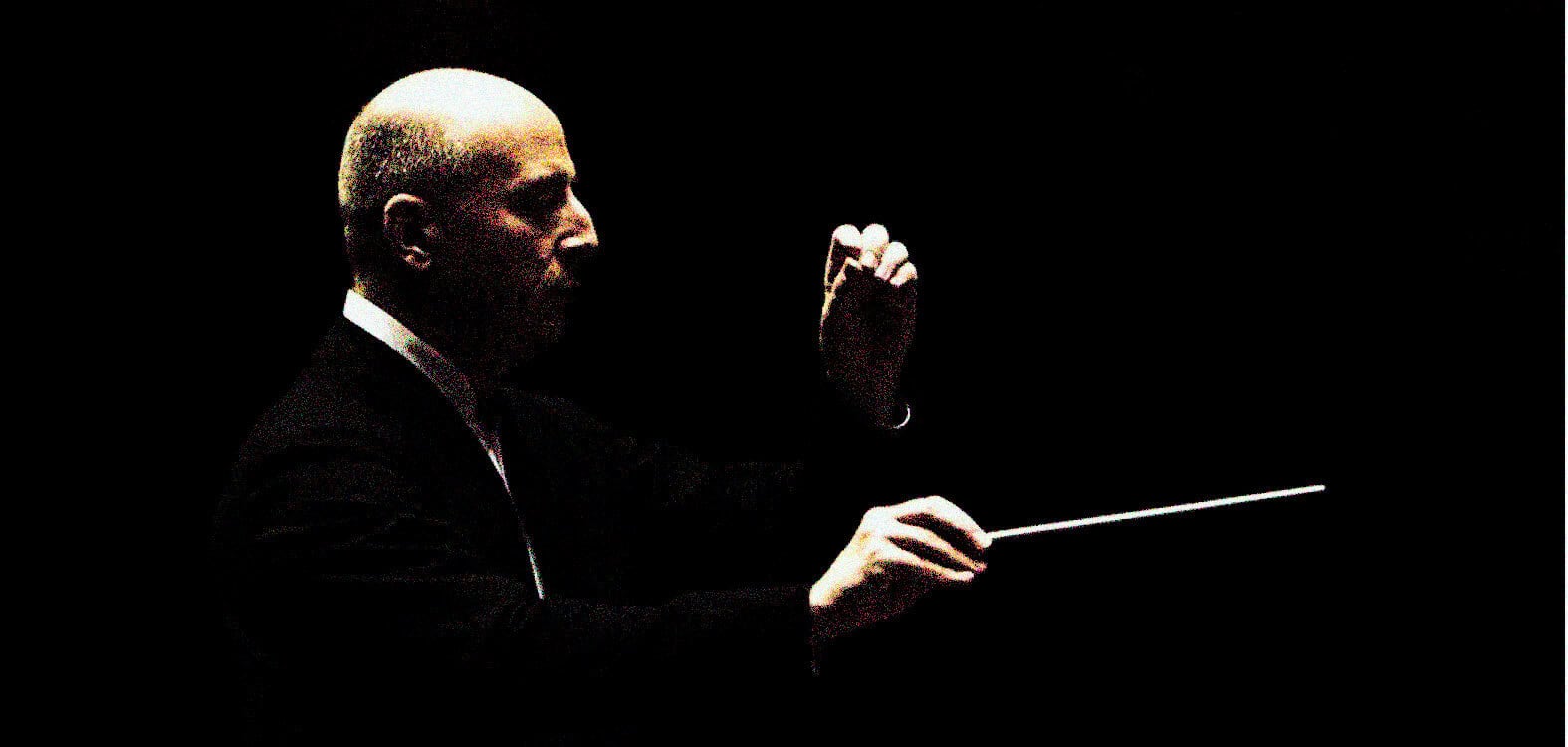 A sound archive of news, history, and music featuring a conductor directing with a baton in a dark setting for vintage news and music recordings.