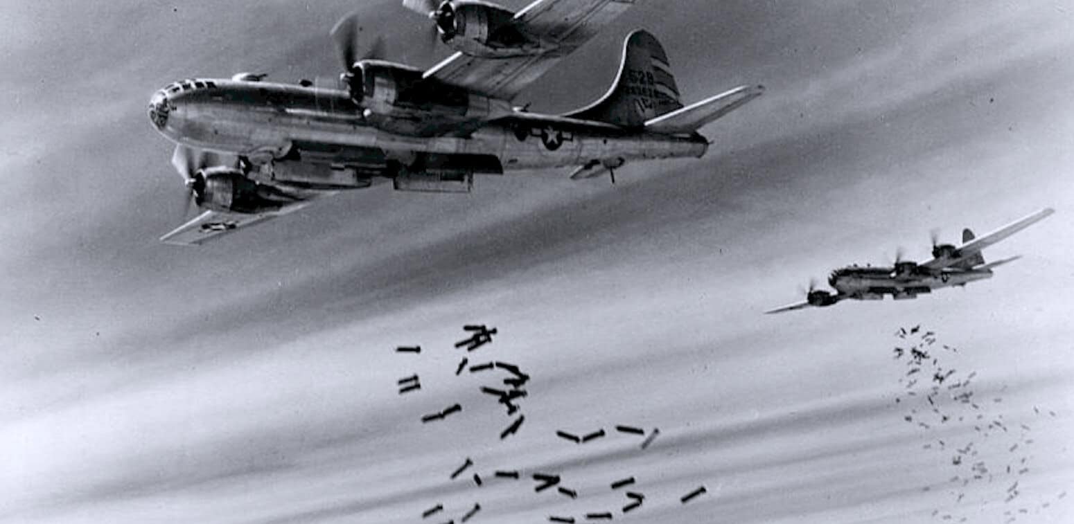 WWII bombers dropping bombs from the sky, historical military aircraft in flight, black and white wartime aerial combat image, iconic warfare scene from World War II.