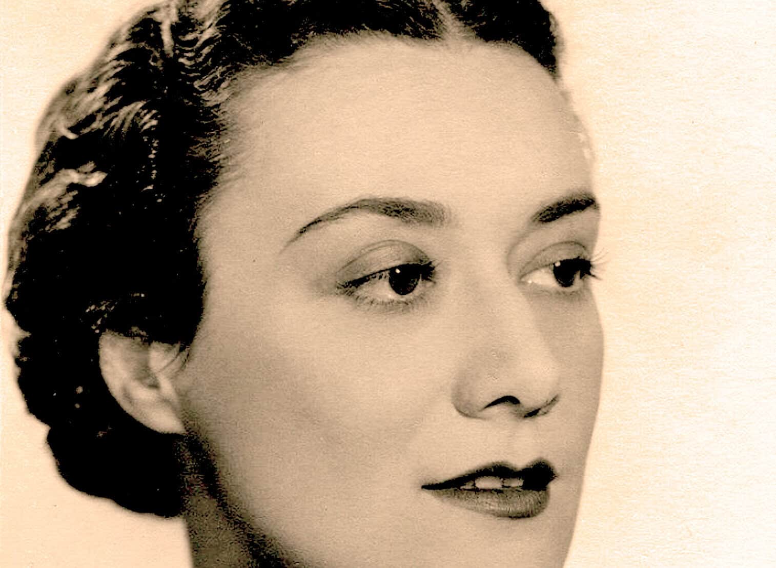 Close-up black and white portrait of a woman with vintage hairstyle, emphasizing classic beauty and elegance, suitable for historical or musical archives.