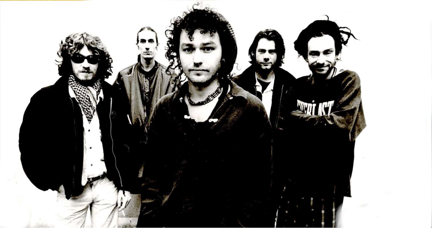 Rock band in black and white photo, featuring five members with distinctive hairstyles and clothing, representing music history and alternative rock genre, emphasizing iconic music and cultural influence.