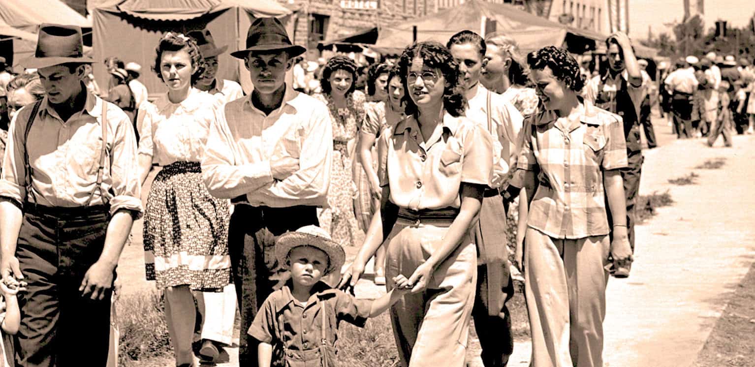 Vintage Black and White Photo of People Walking at a Fair or Market, Historical Scene.