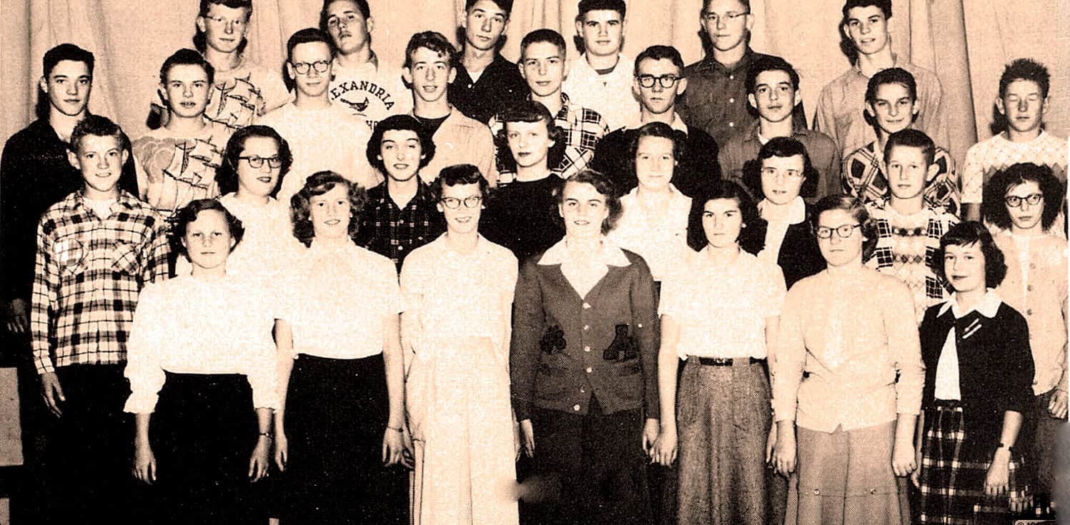 Historical school class photo with students and teachers, vintage black and white image, educational setting, mid-20th century.