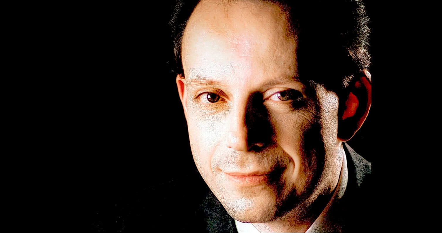 A sound archive of news, history, and music featuring a portrait of a man in a professional setting, emphasizing historical audio collections and media preservation.