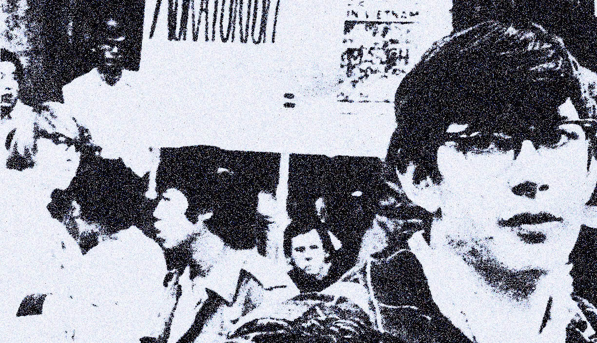 Young boy with glasses in a black and white historical photo at a news, history, and music archive.