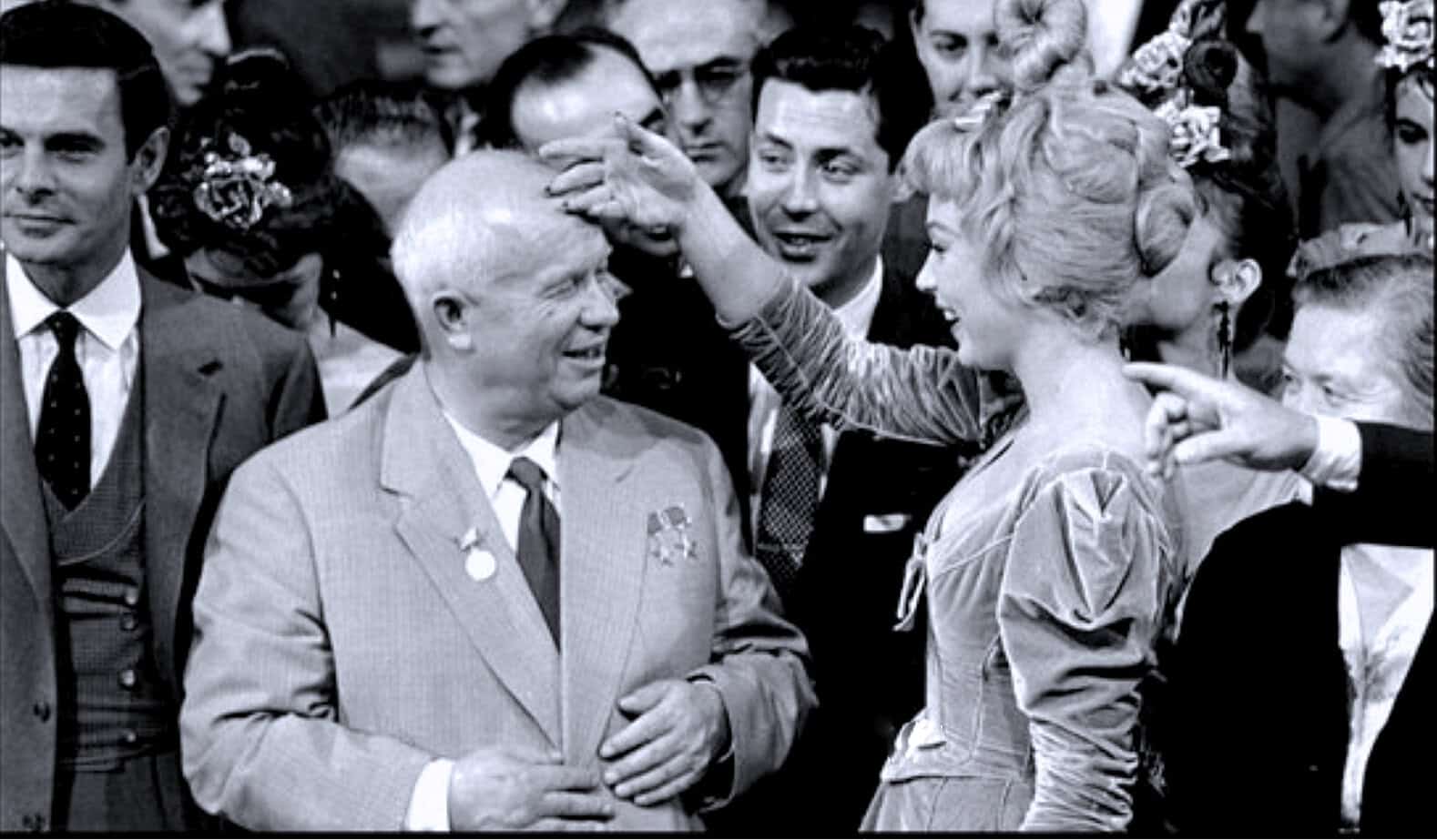 Medal award ceremony with women in traditional dress congratulating a man, vintage black and white photo, historical event, celebration of achievement, famous public figures, news, history, music, sound archive, Past Daily.