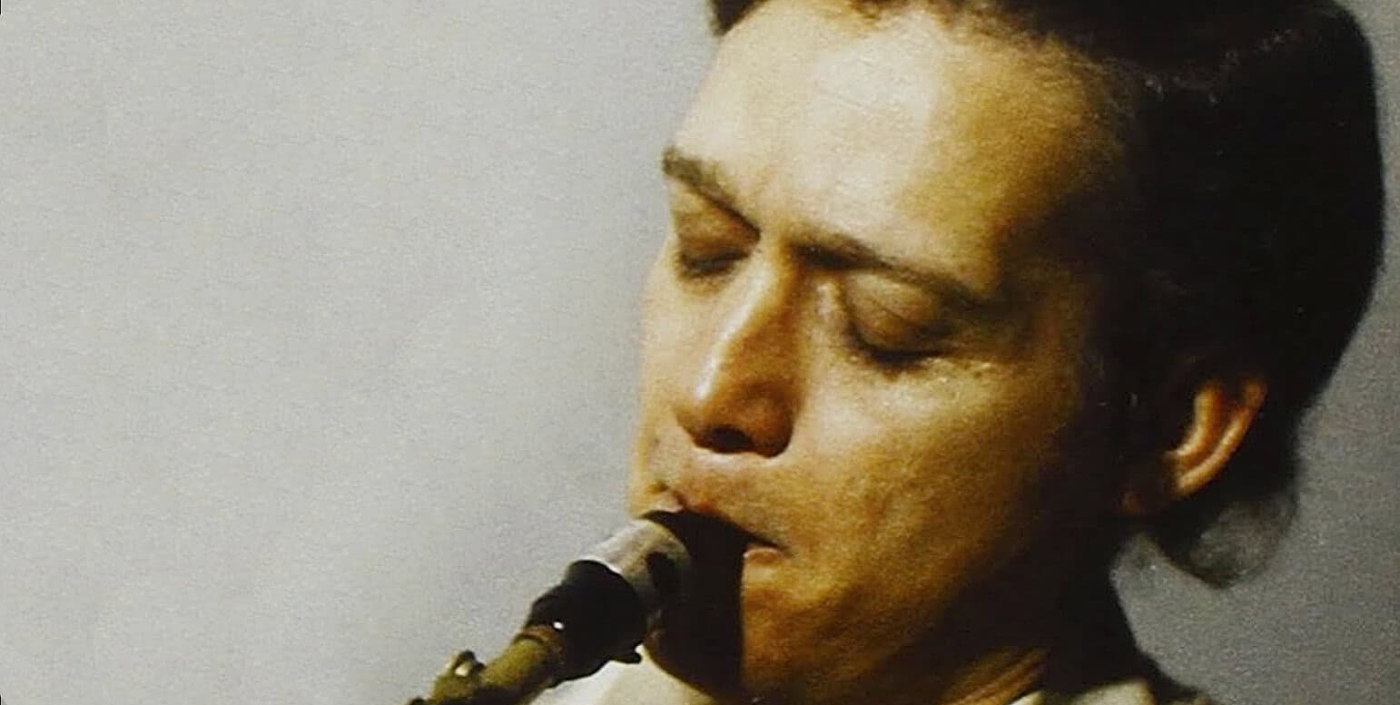 Close-up of a woman playing the saxophone, focusing on her face and instrument, highlighting jazz music and musical history themes.