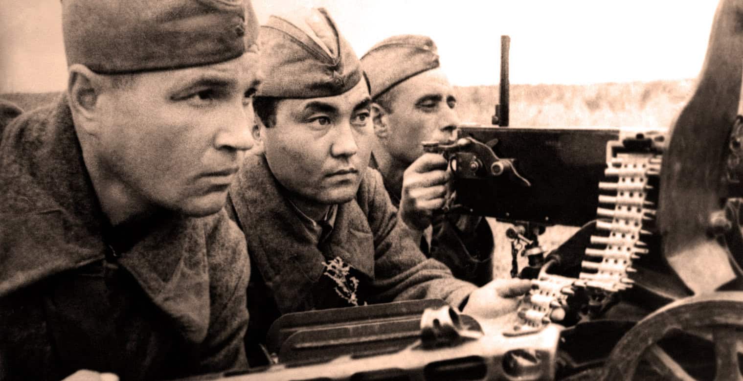 German soldiers during World War II operating machine guns in a historical wartime photograph.