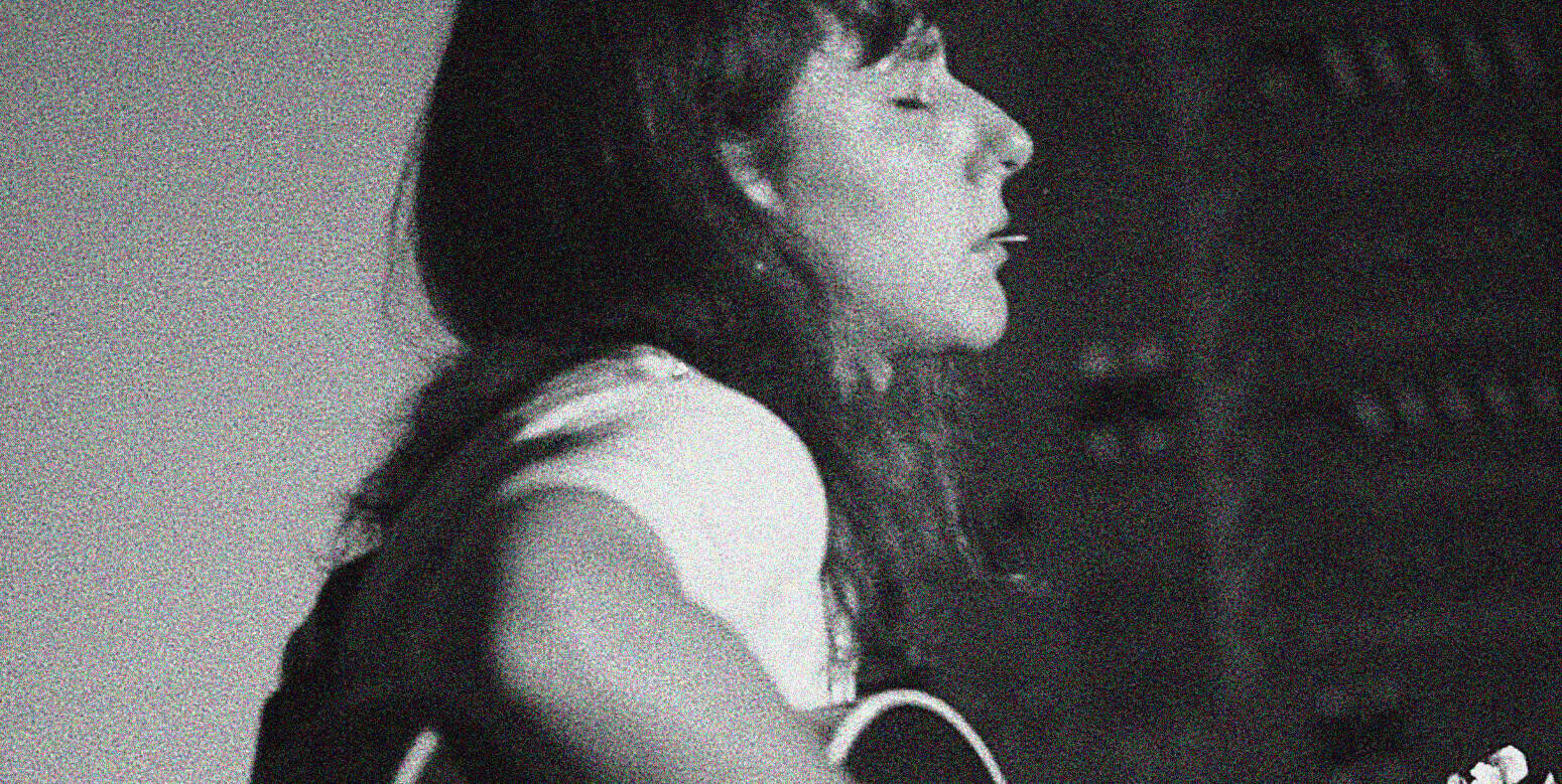 A serene woman with closed eyes, expressing peacefulness and reflection, emphasizing the nostalgic and historical sound archive themes of Past Daily.