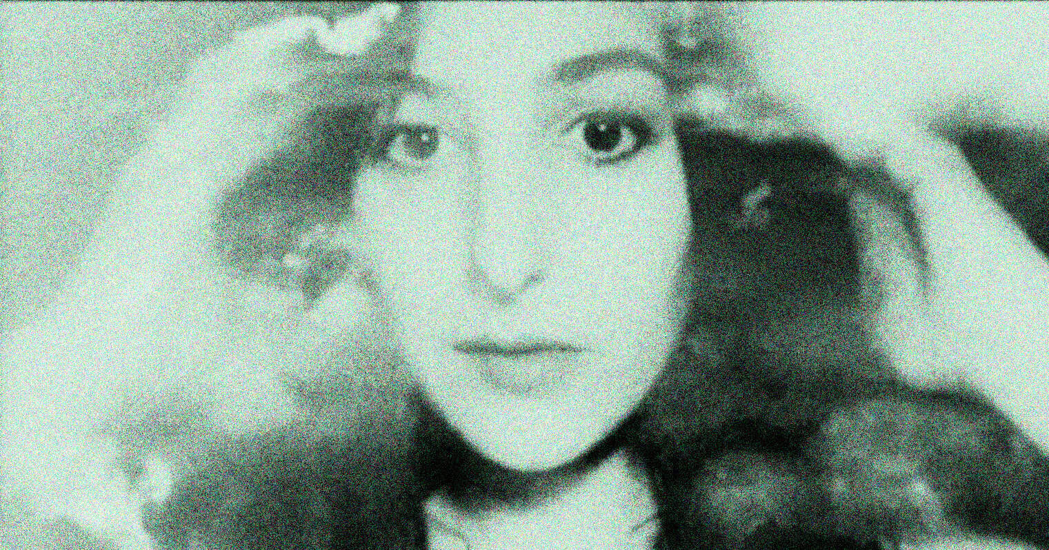 Vintage black and white photo of a young woman with curly hair, symbolizing historic news, music, and cultural archives from Past Daily.