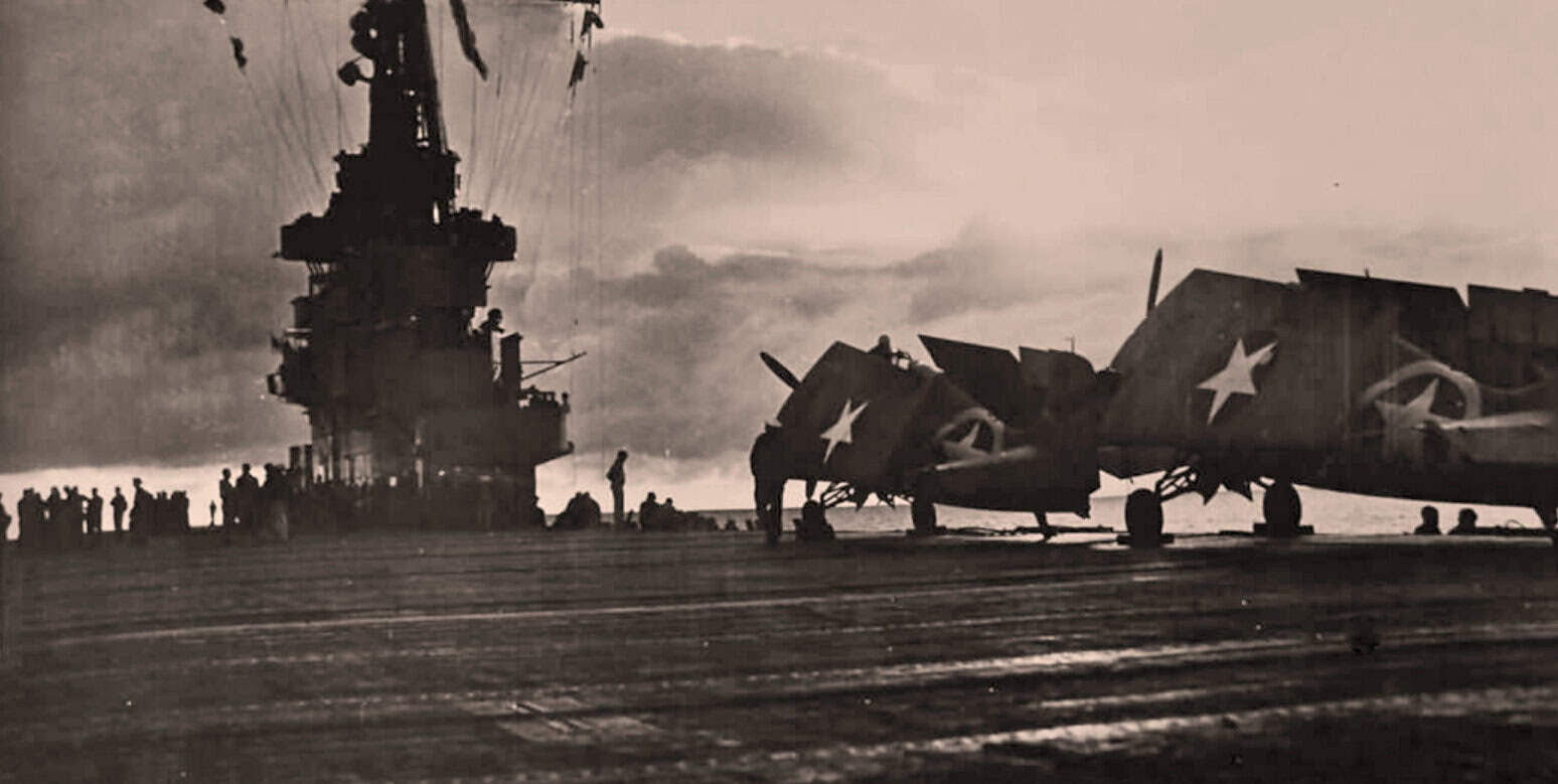 Fighter jets and aircraft on aircraft carrier deck during sunset, military aviation history, naval warfare, past Daily news archive.
