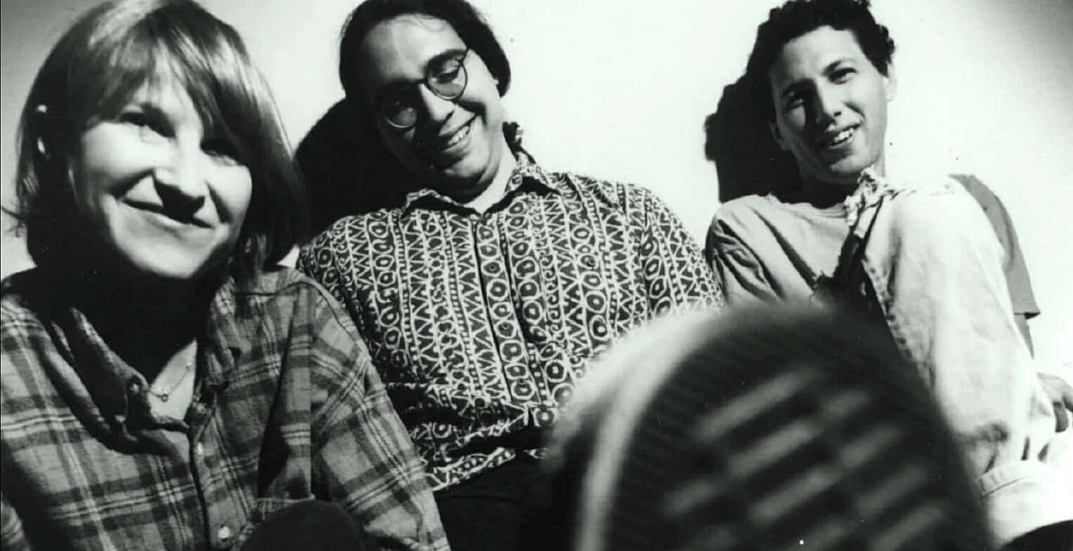 People smiling and enjoying music in a black and white vintage photograph, capturing moments of news history, cultural expression, and archival sound recordings.
