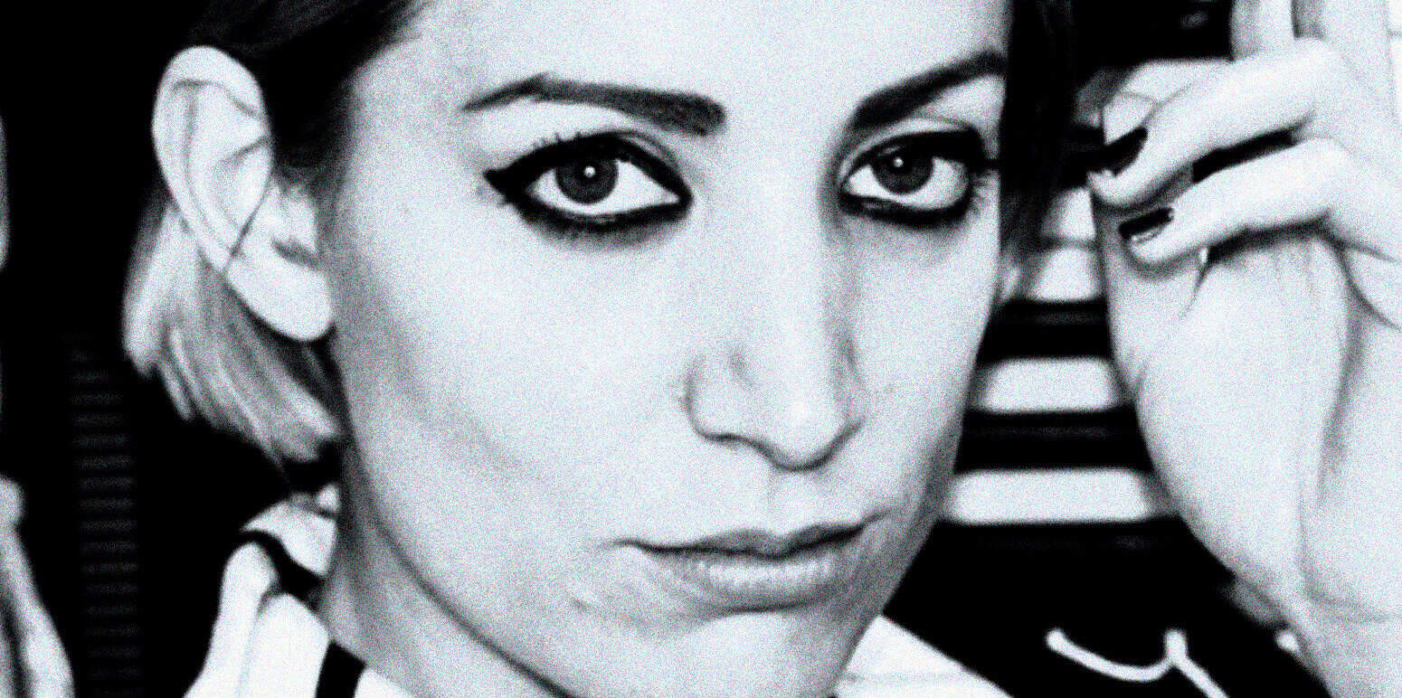 Vintage black and white portrait of a woman with bold eyeliner, short blonde hair, and striking features, representing a classic photograph related to music, news, and history archives.