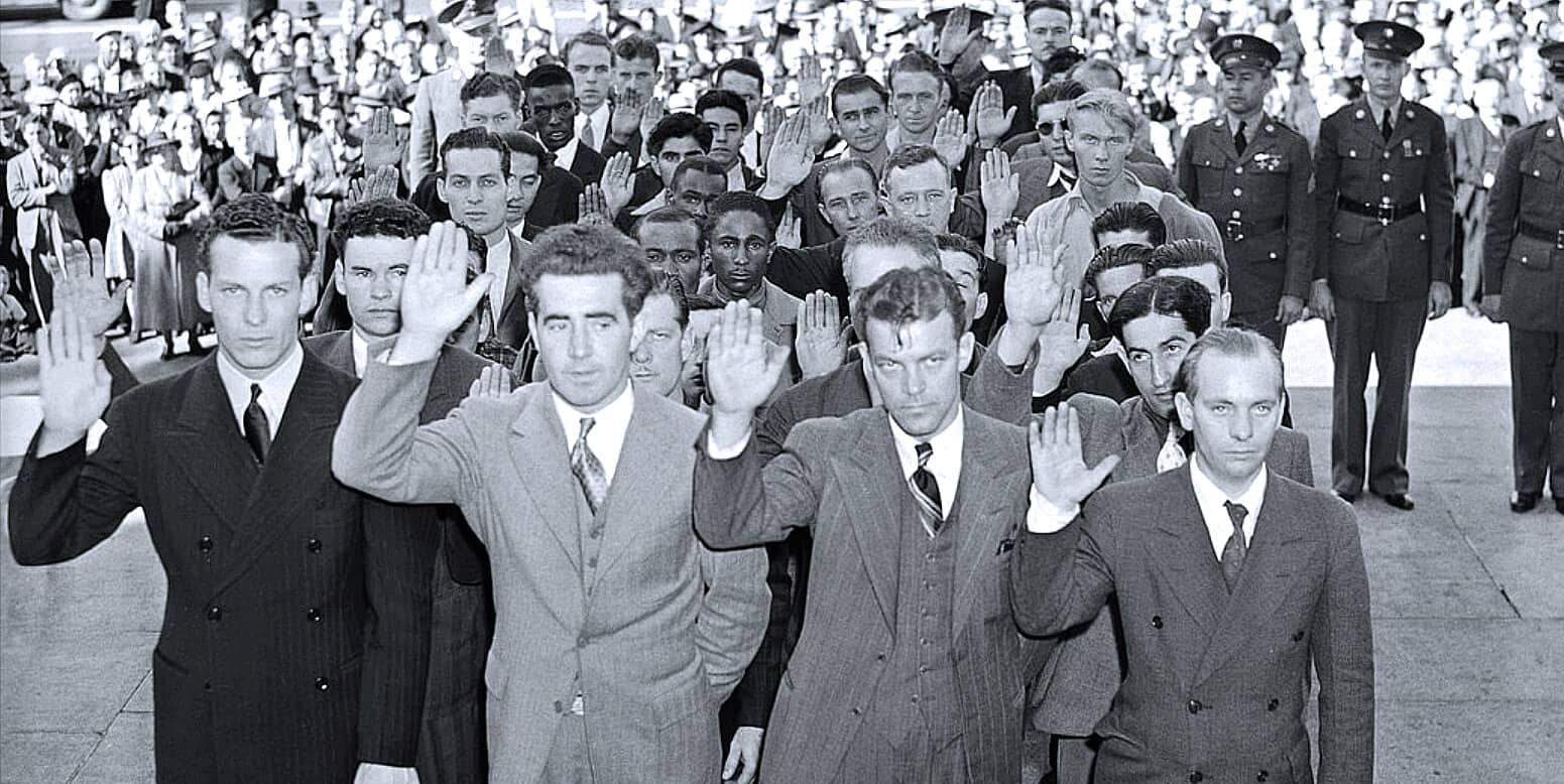 Black and white photo of men taking an oath or vow during a historical civil rights event, with military personnel in uniform witnessing, symbolizing themes of protest, history, and social justice, from a vintage news archive.
