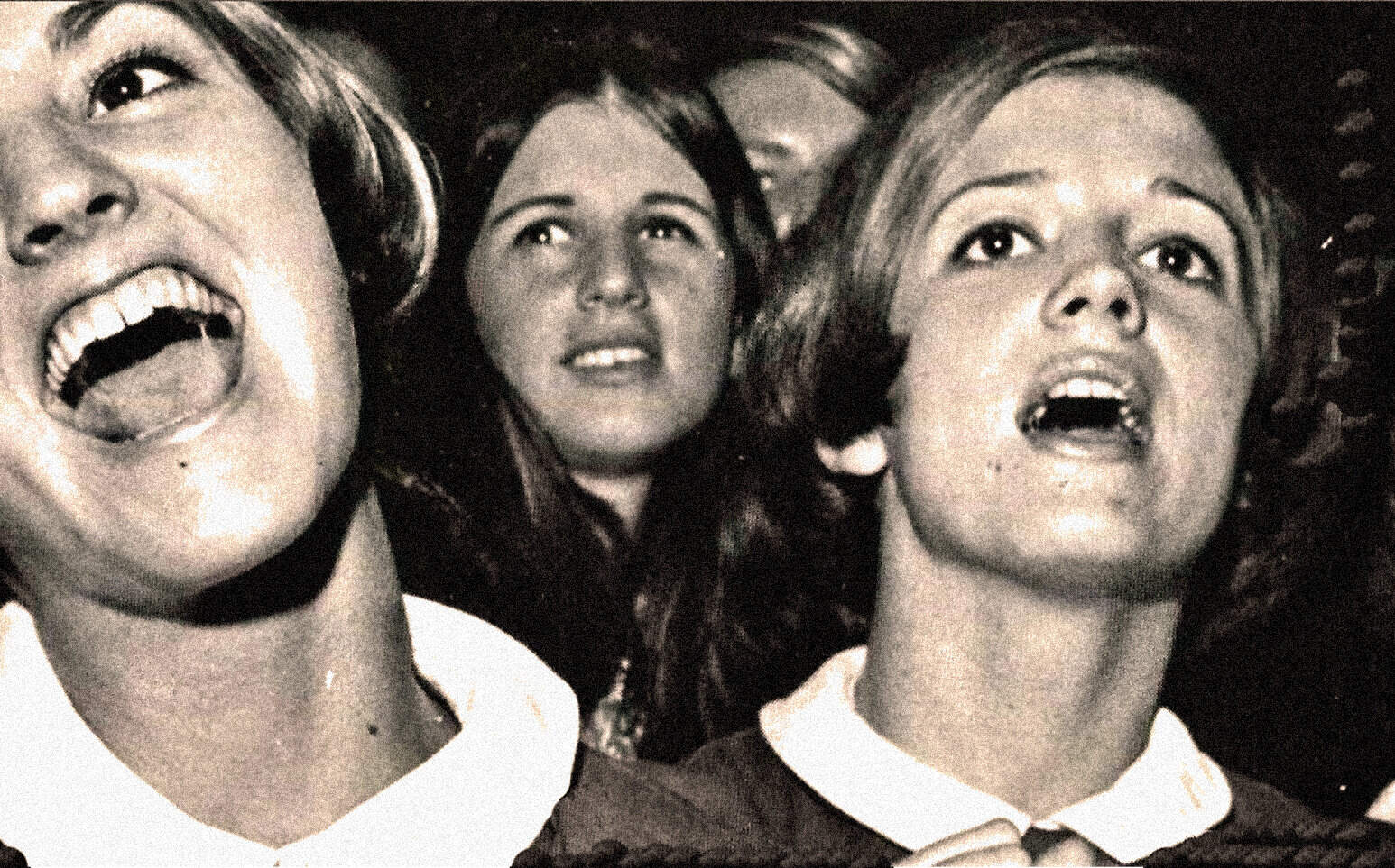 Women singing passionately at concert, black and white photo, vintage music performance, live music, historical concert photo, classic rock band, timeless music scene, iconic live performance, archival music photo, cultural music history relevance.