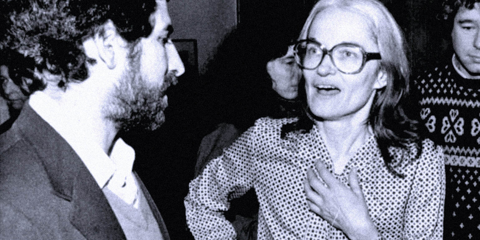 Vintage black and white photo of a woman with glasses speaking passionately to a man with curly hair, illustrating historical conversations and news archives.