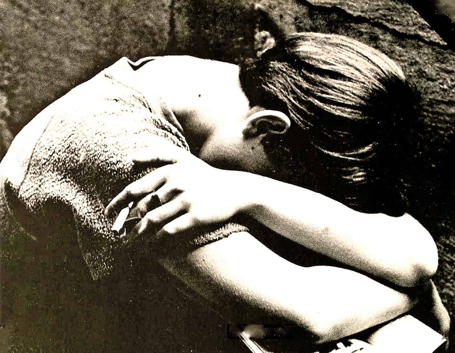 Child sleeping peacefully on a textured blanket, black and white photo representing comfort, innocence, or restful moments.