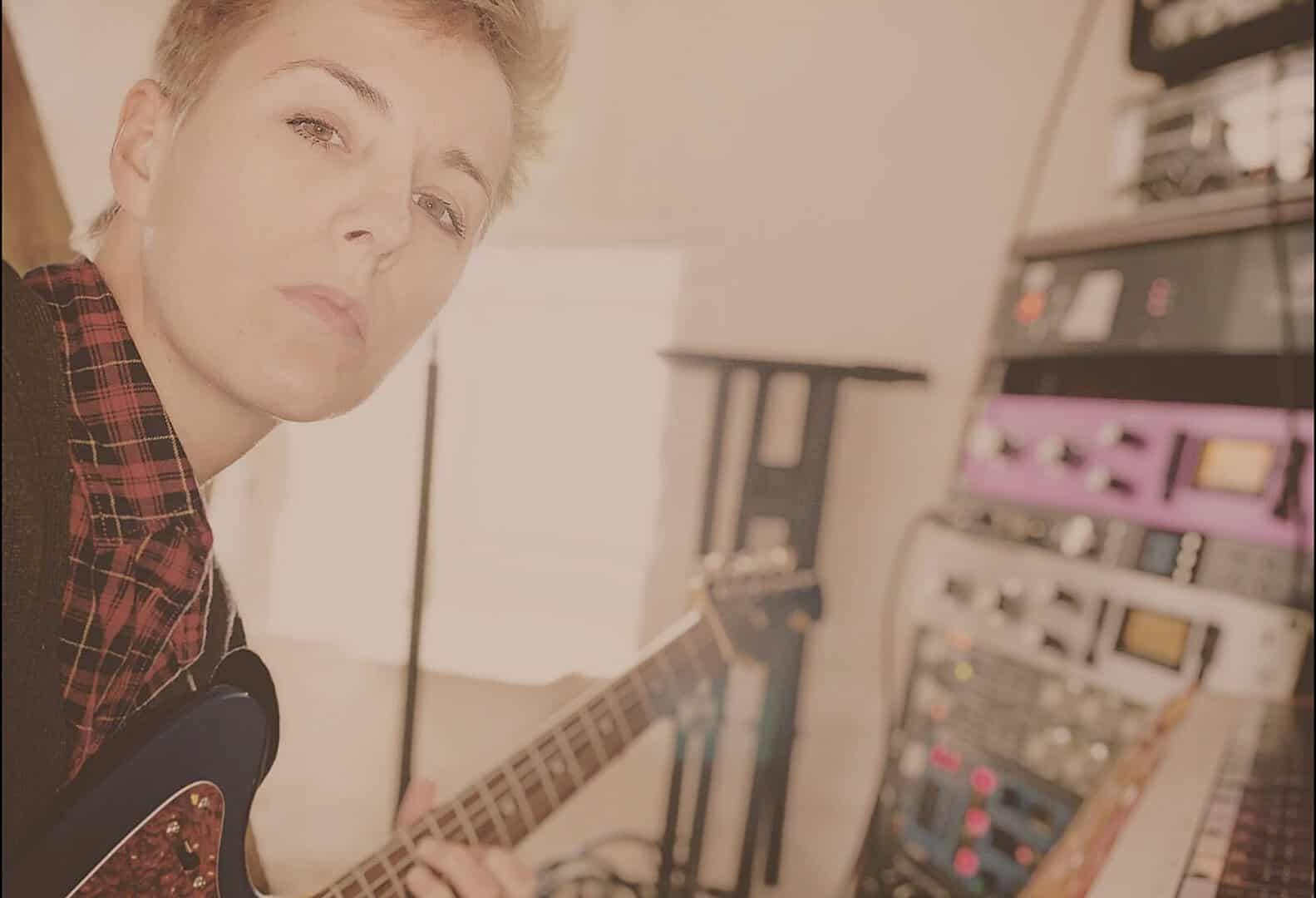 Vintage musician recording music in a studio with synthesizers and sound equipment for a music archive.