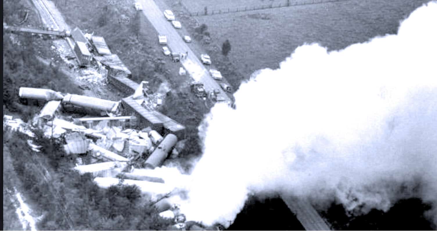 Crash site of a train derailment with smoke and debris, historic transportation disaster, vintage black and white photo of an accident, past daily archive of news and history, music and historical news archive.