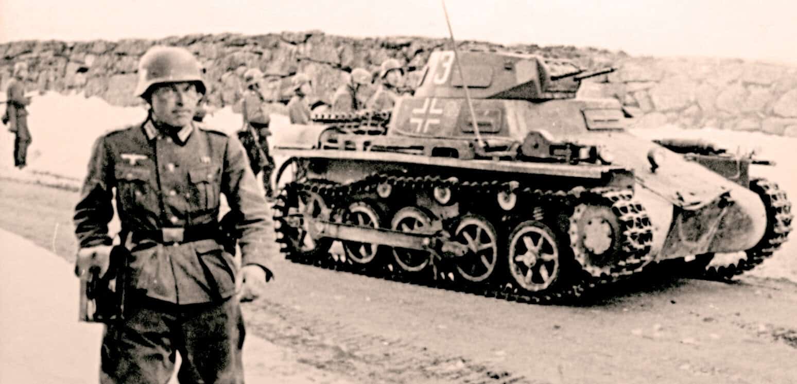 Deactivated German WWII tank with soldier in uniform, historical military photo, World War II armor, vintage wartime history, military memorabilia, Past Daily archive content.