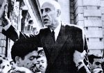 Respected man in suit passionately speaking to crowd outside, historical black and white photo, likely related to news, politics, or social movements, representing key moments in history and journalism.