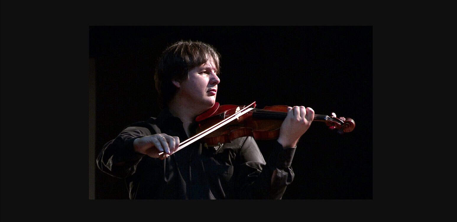 Violinist playing music, live performance, classical music, musician, art event, Past Daily news archive relevance.