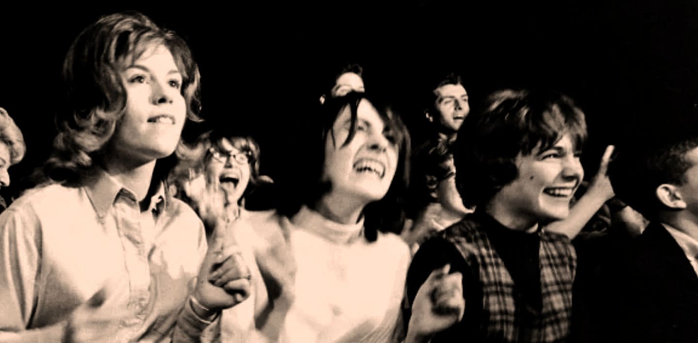 People enjoying a nostalgic music concert at Past Daily sound archive of news, history, and music, capturing iconic moments in musical history with lively audience reactions.