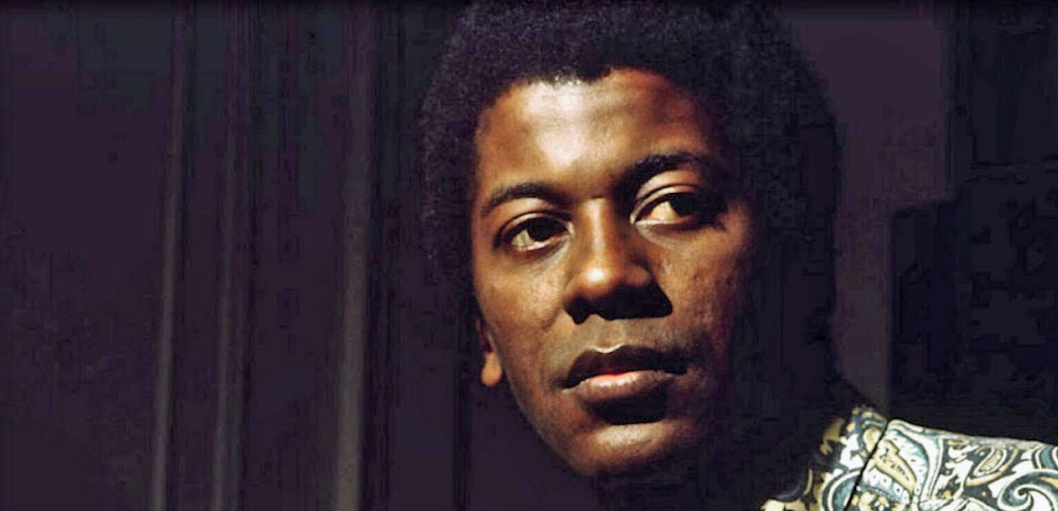 Vintage black and white photo of a man with afro hairstyle, emphasizing historical music and news archives, for content related to Past Daily's sound archive of news, history, and music.