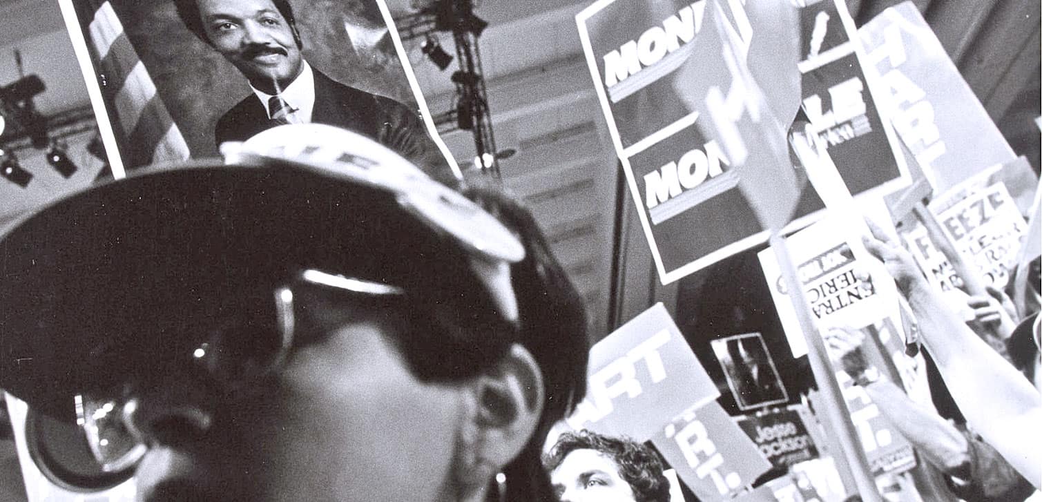 Photo of a person with headphones at a news and music archive event with campaign posters and banners, representing Past Daily's sound archive of news, history, and music.