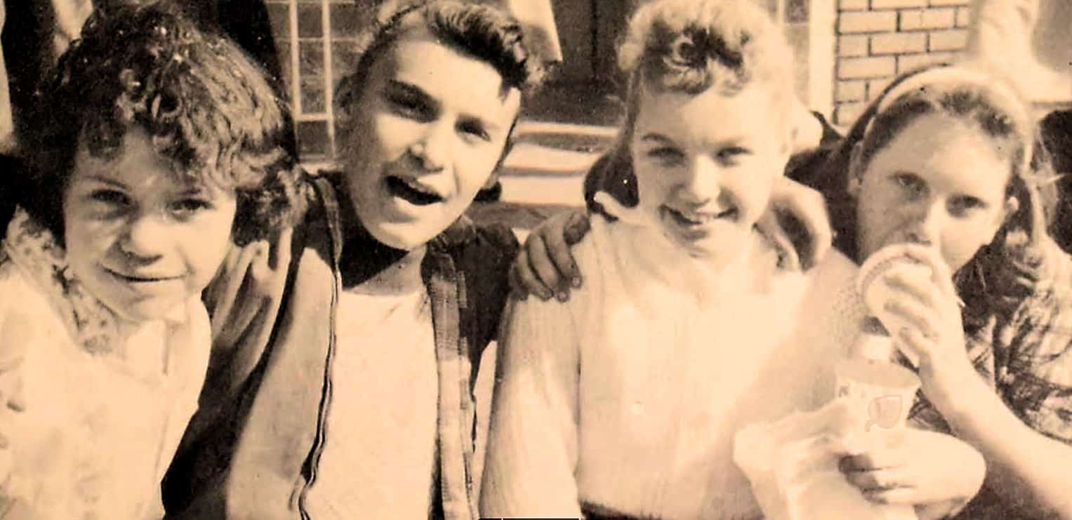 Kids enjoying music and friendship at a past social gathering, capturing nostalgic moments and emphasizing vintage family enjoyment and musical memories.