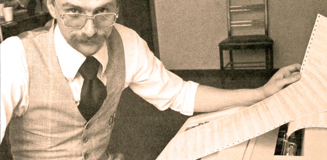 Historic man reading sheet music or a document in an archive setting, capturing vintage radio or music history.
