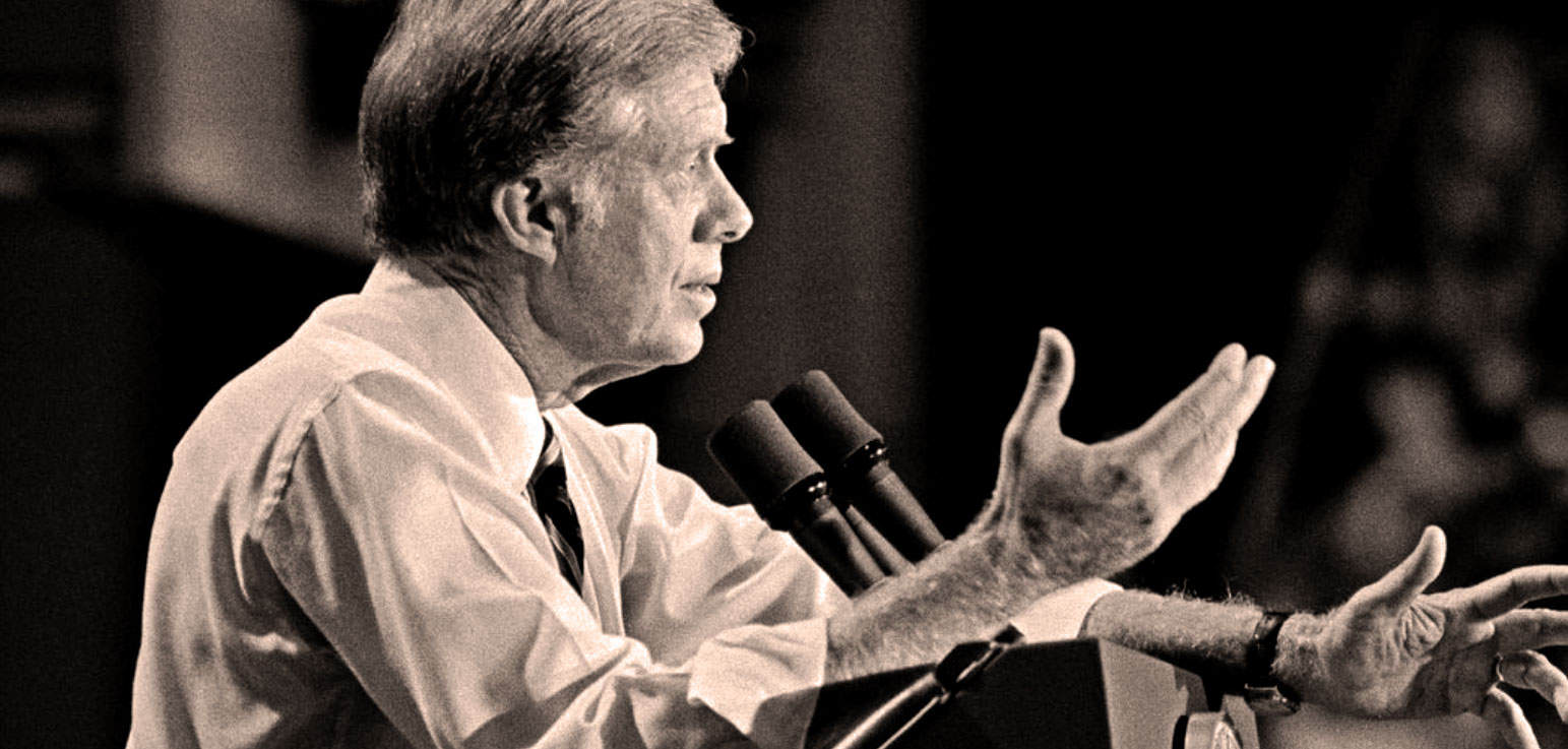 Radio commentator speaking at a press conference with microphones, representing news history and sound archives.
