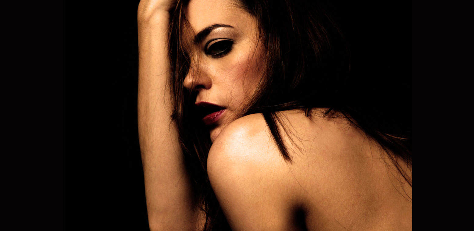 A sound archive website featuring news, history, and music, with an artistic portrait of a woman with dark hair and makeup on a black background.